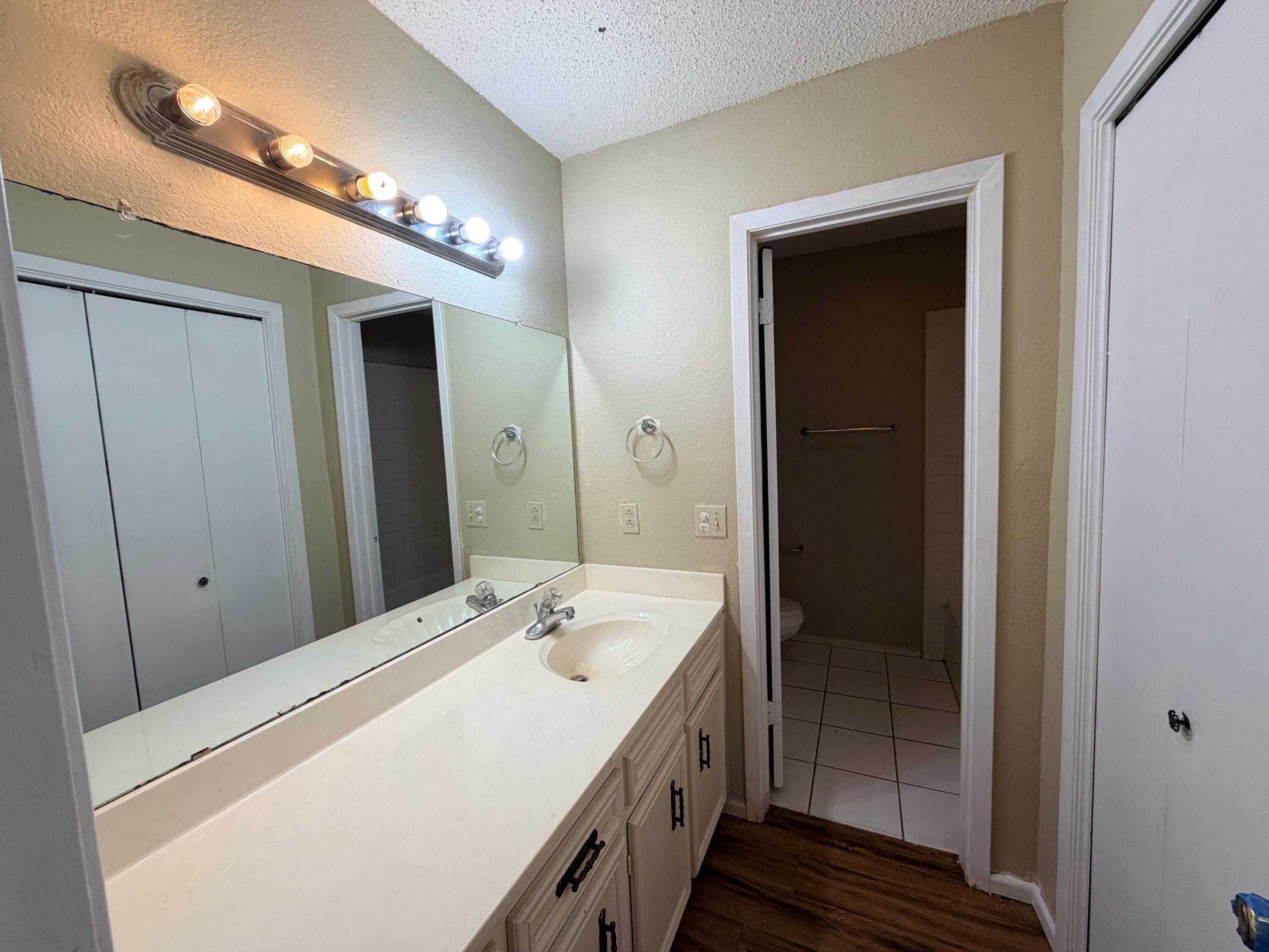 3314 81st Street, Unit B Lubbock, TX 79423 - Photo 7 of 18 a bathroom with a double vanity sink and a mirror