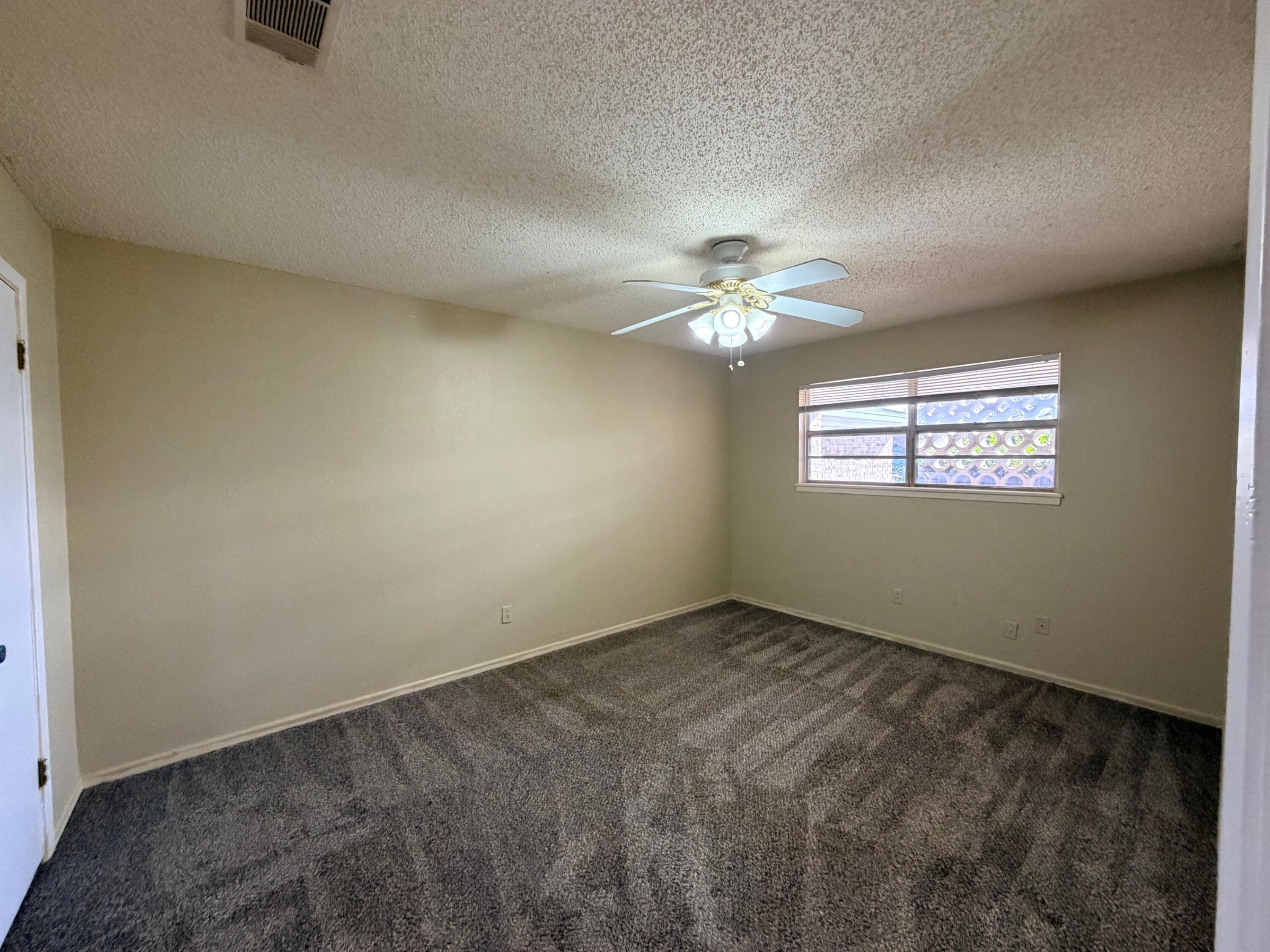 3314 81st Street, Unit B Lubbock, TX 79423 - Photo 8 of 18 a view of an empty room with a window