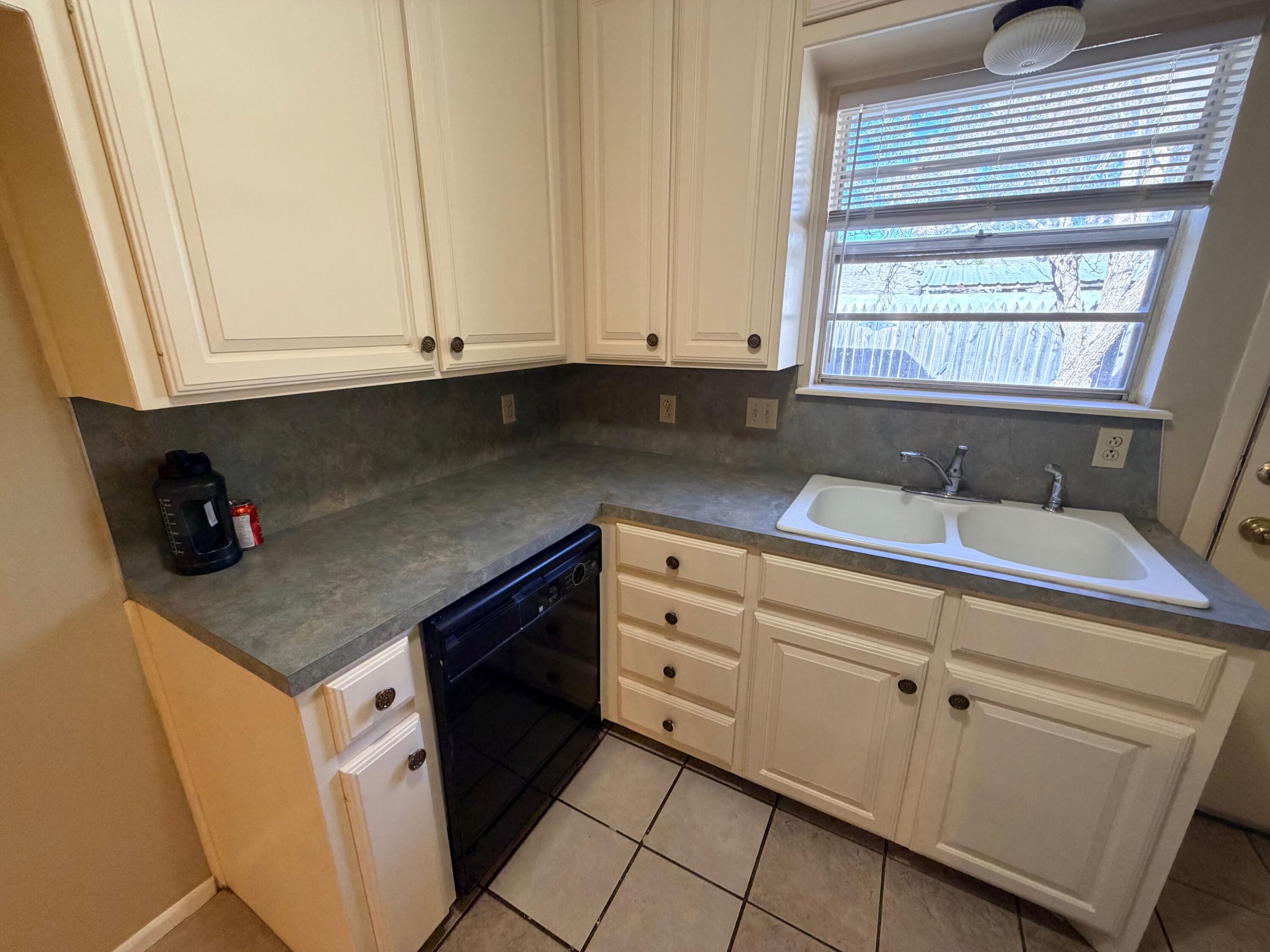 3314 81st Street, Unit B Lubbock, TX 79423 - Photo 10 of 18 a kitchen with granite countertop white cabinets and sink