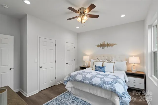 a bedroom with bed and a chandelier