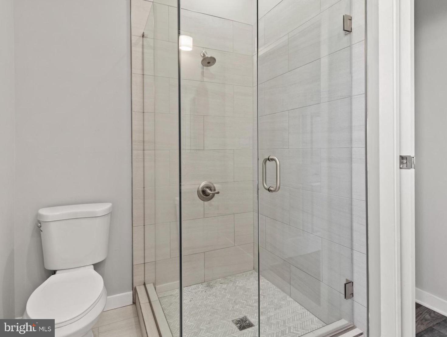 2303 Christian Street Philadelphia, PA 19146 - Photo 22 of 26 a white toilet next to a bathroom