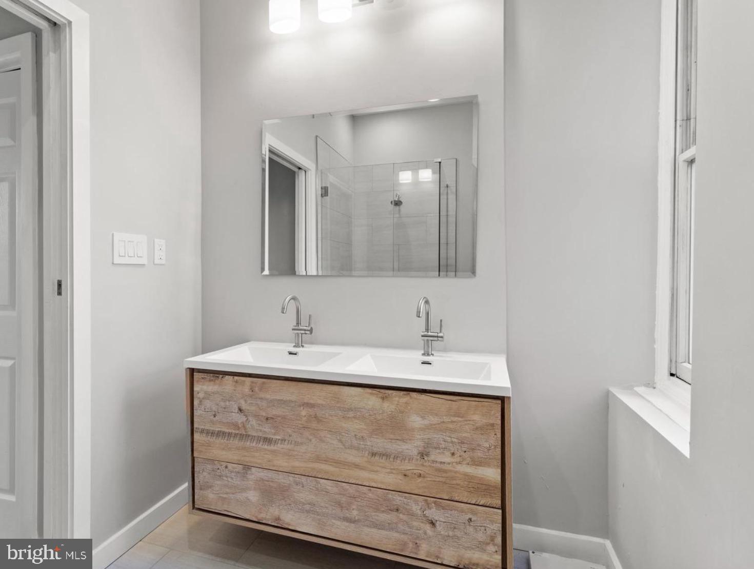 2303 Christian Street Philadelphia, PA 19146 - Photo 24 of 26 a bathroom with a sink and a mirror