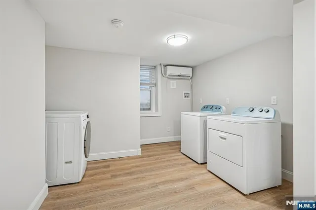 a utility room with cabinets washer and dryer