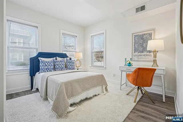 a bedroom with a bed a table and chair