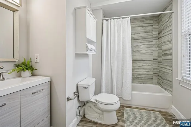 a bathroom with a toilet a sink and shower
