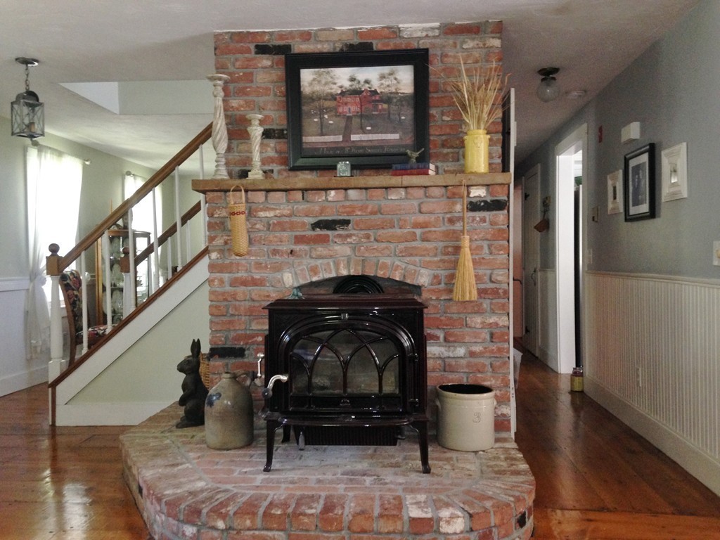 111 Bay Road Easton, MA 02356 - Photo 15 of 30 a living room with furniture a flat screen tv and a fireplace