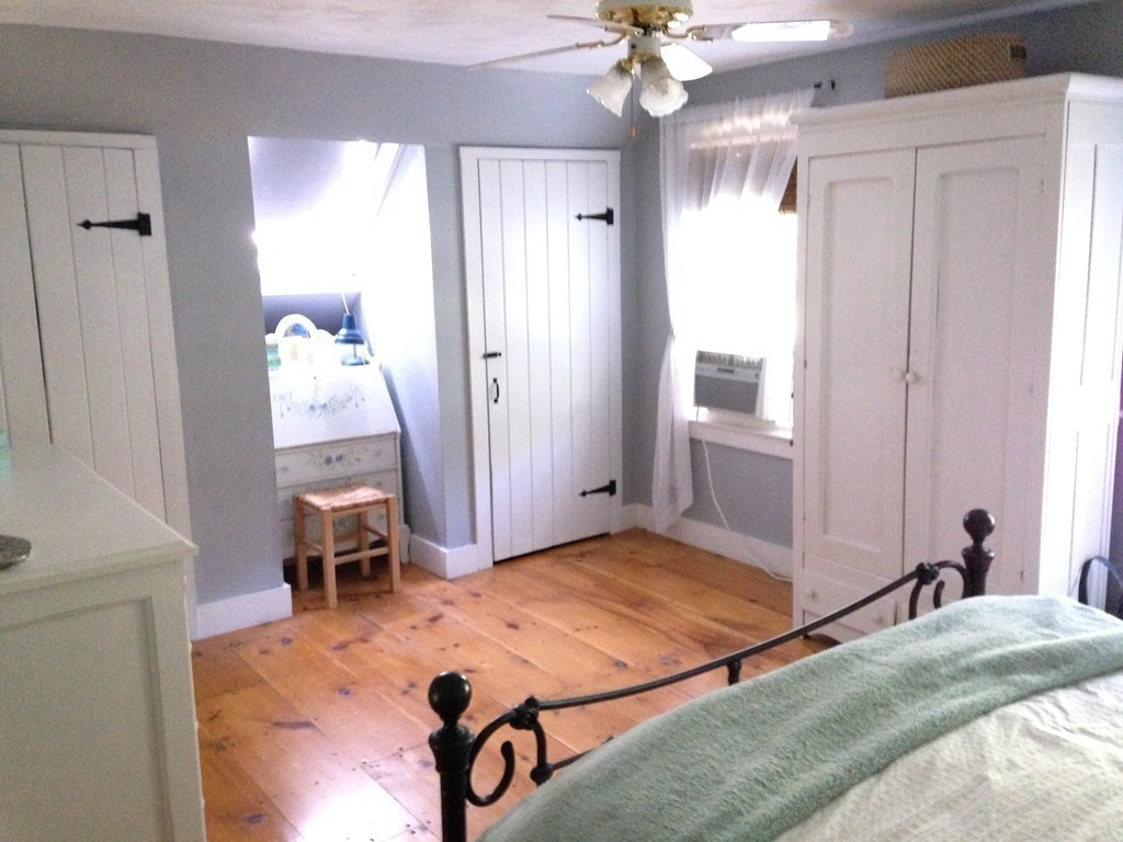 111 Bay Road Easton, MA 02356 - Photo 20 of 30 a bedroom with a bed and a chandelier