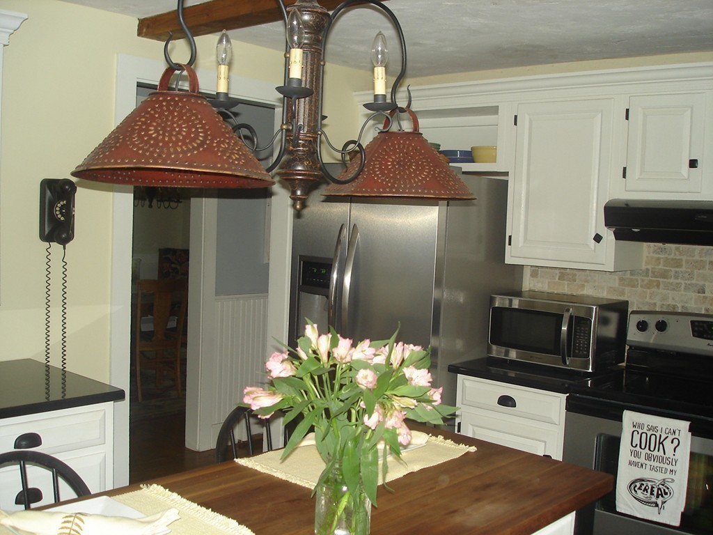 111 Bay Road Easton, MA 02356 - Photo 9 of 30 a kitchen with stainless steel appliances kitchen island granite countertop a refrigerator a stove a microwave oven with white cabinets and wooden floor