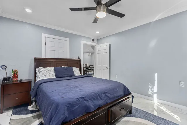 a spacious bedroom with a bed and a chandelier