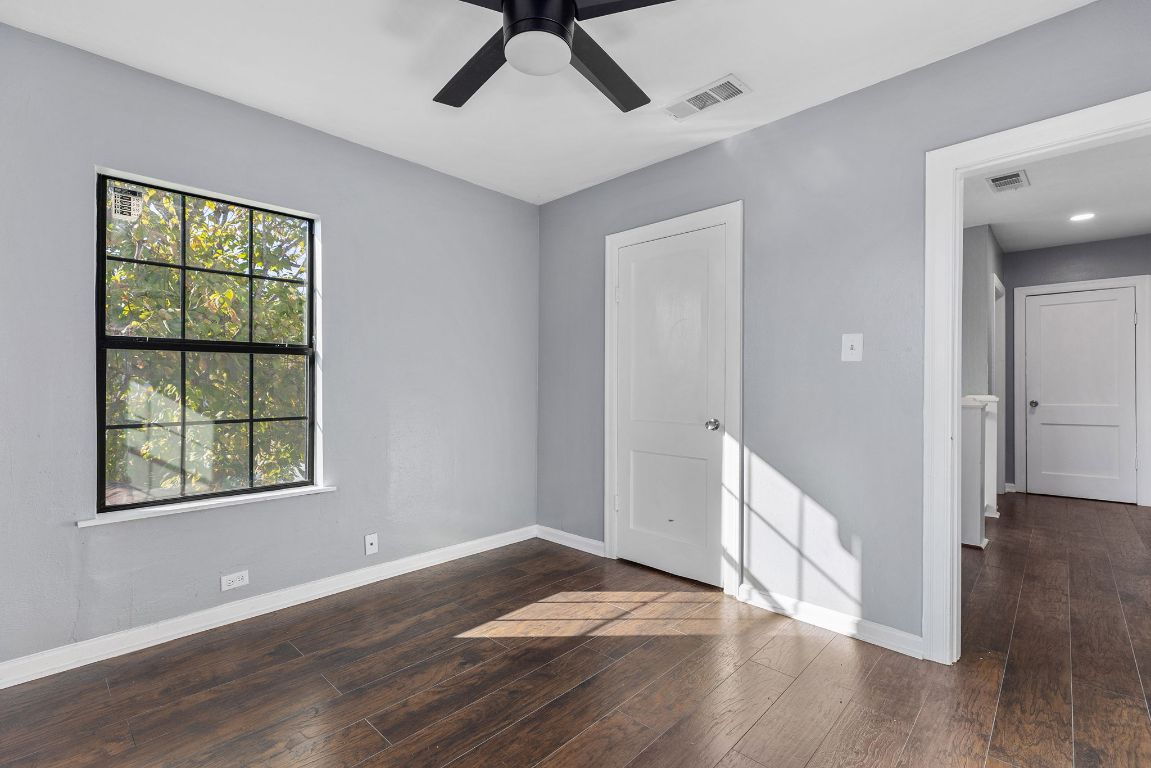 1110 South 9th Street Temple, TX 76504 - Photo 21 of 27 a view of an empty room with wooden floor and a window