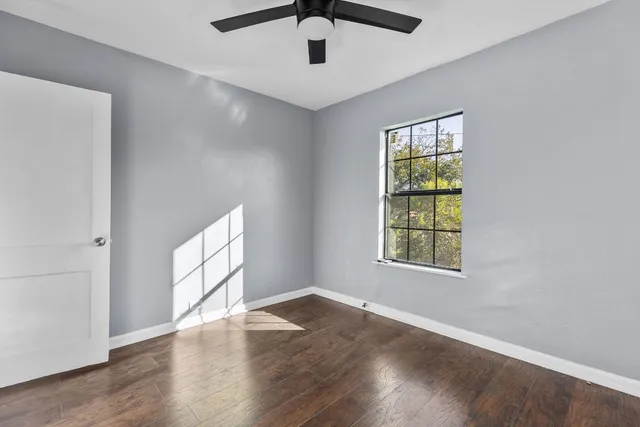 wooden floor in an empty room with a window