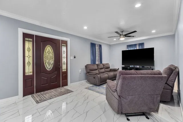 a living room with furniture and a flat screen tv