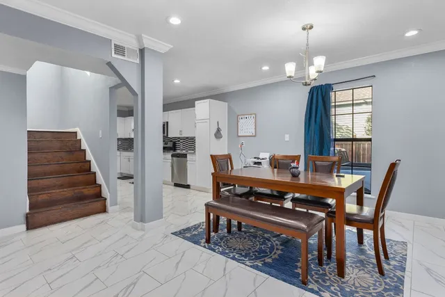 a dining room with furniture and wooden floor