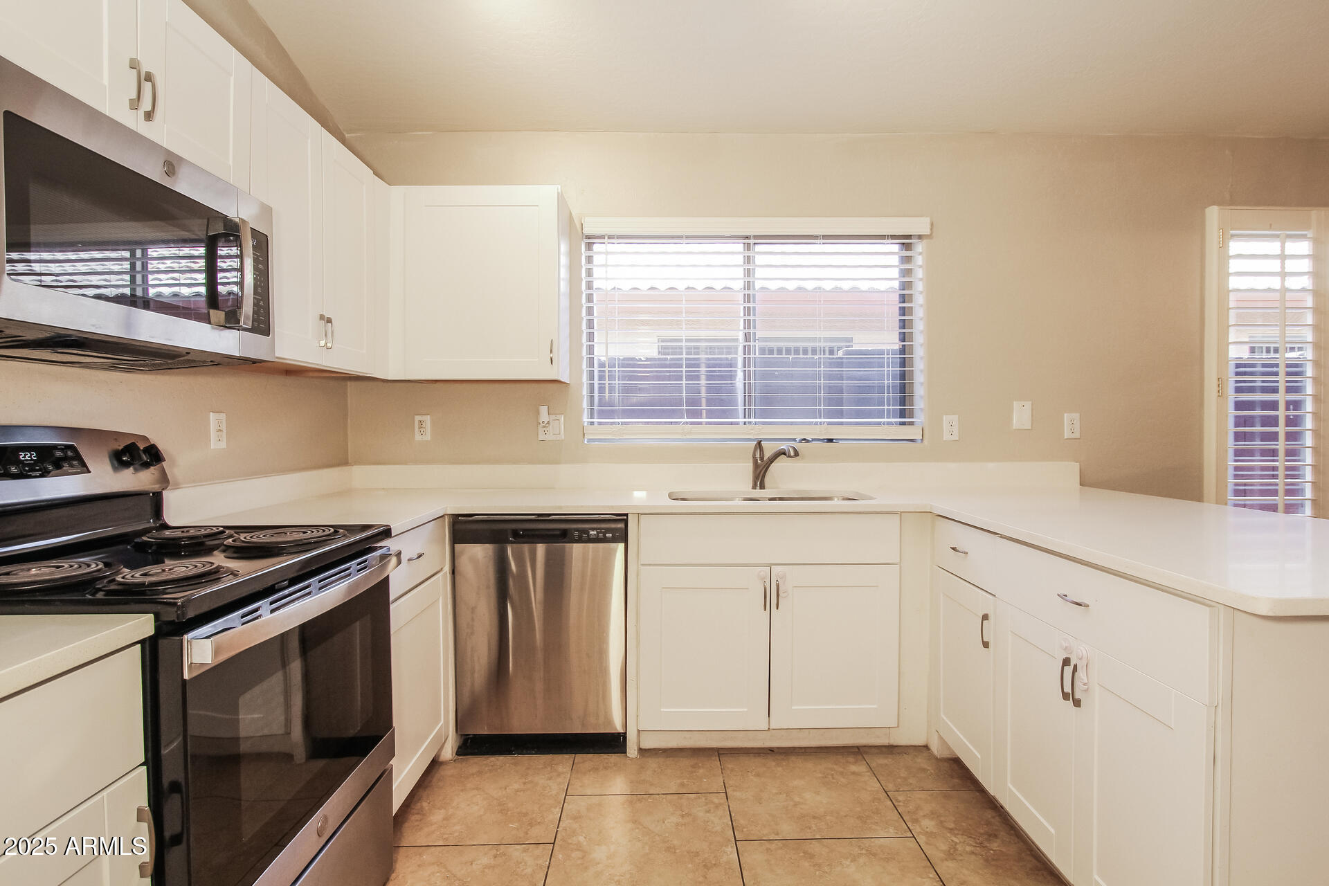 3750 South Conestoga Road Apache Junction, AZ 85119 - Photo 8 of 21 a kitchen with granite countertop white cabinets and white appliances