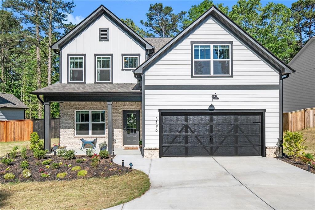 3196 Shadyside Road Southwest Marietta, GA 30008 - Photo 1 of 1 a front view of a house with a yard and garage