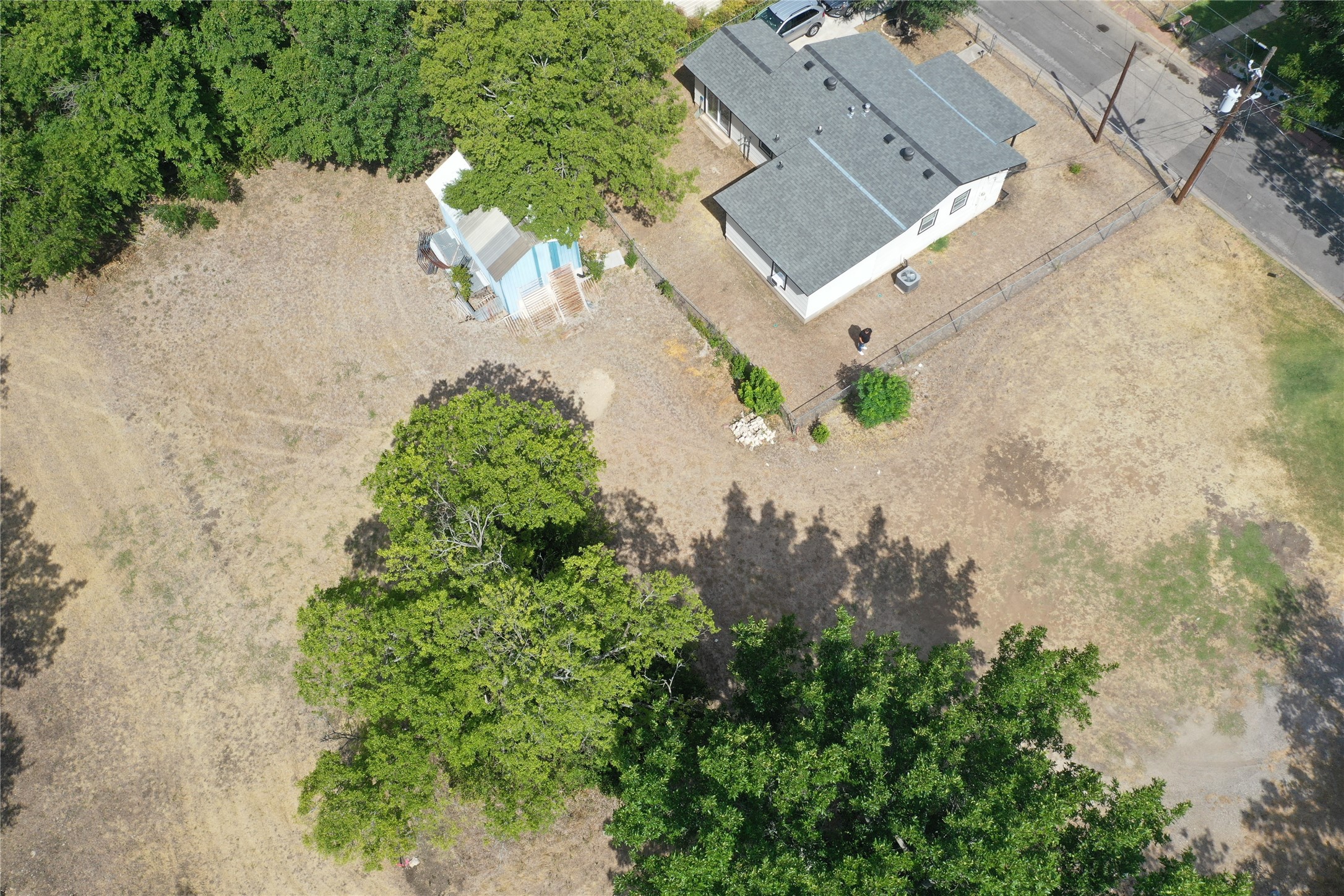 910 East 20th Street Georgetown, TX 78626 - Photo 18 of 19 an aerial view of a house with a yard and a pond