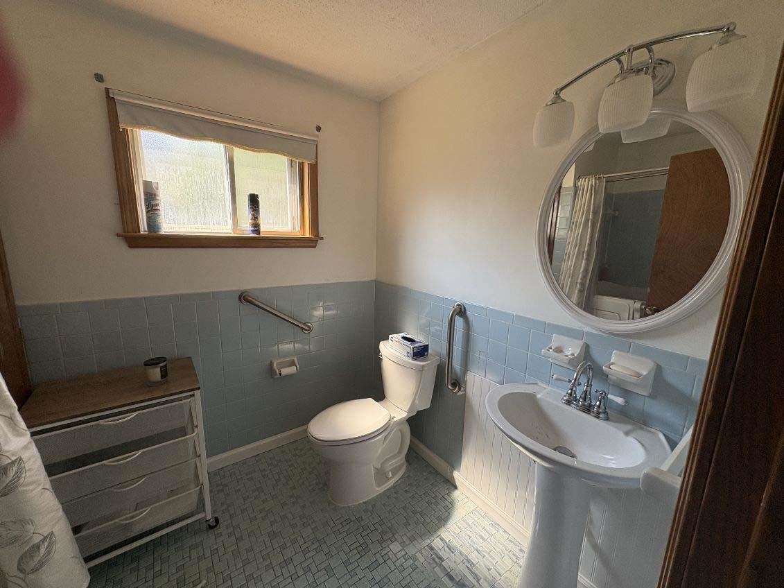 8355 Craven Road Bartlett, TN 38002 - Photo 17 of 28 Full bathroom with tile walls, wainscoting, and a shower with curtain