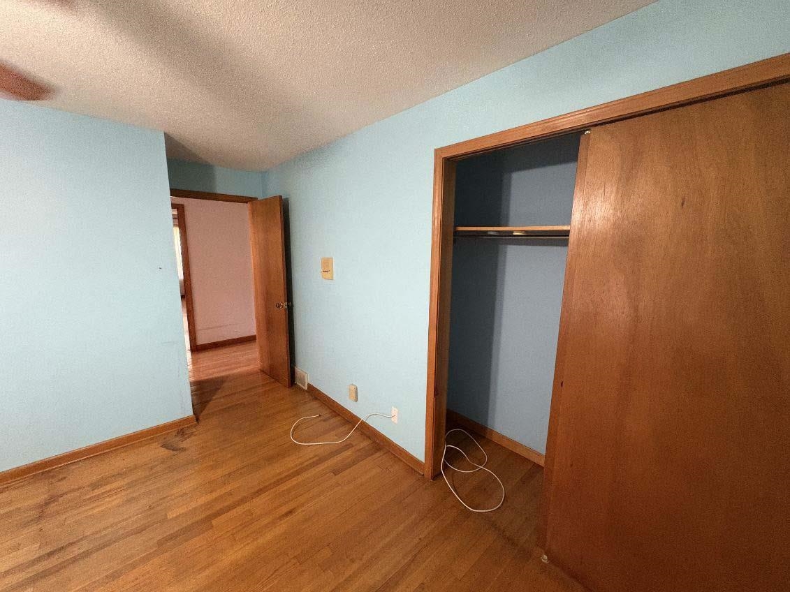8355 Craven Road Bartlett, TN 38002 - Photo 19 of 28 Unfurnished bedroom with wood finished floors, a textured ceiling, and a closet