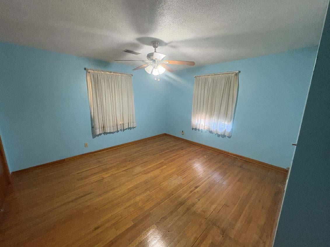 8355 Craven Road Bartlett, TN 38002 - Photo 20 of 28 Empty room with a textured ceiling and wood finished floors