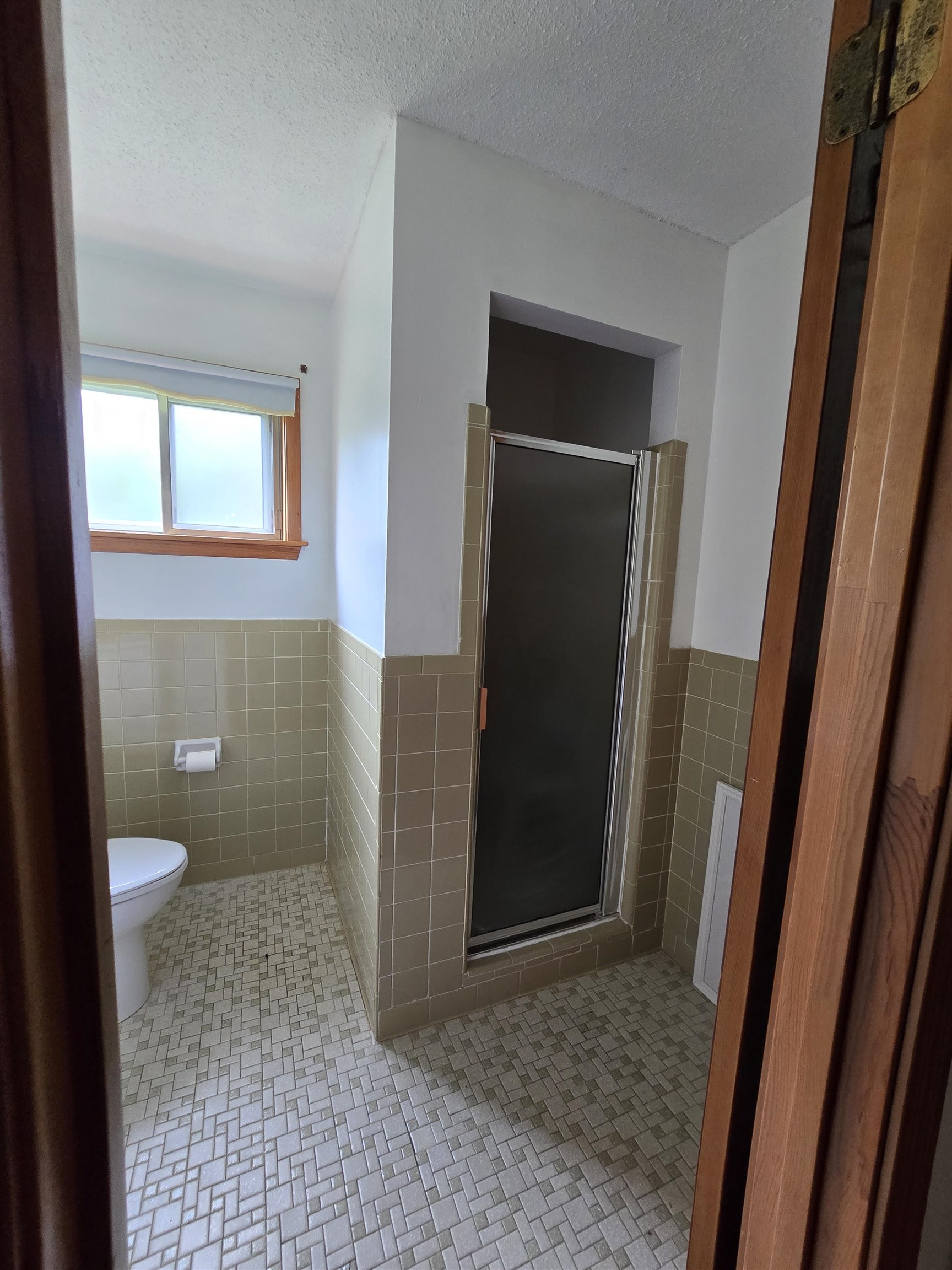 8355 Craven Road Bartlett, TN 38002 - Photo 24 of 28 Full bathroom with tile walls, a stall shower, wainscoting, and a textured ceiling