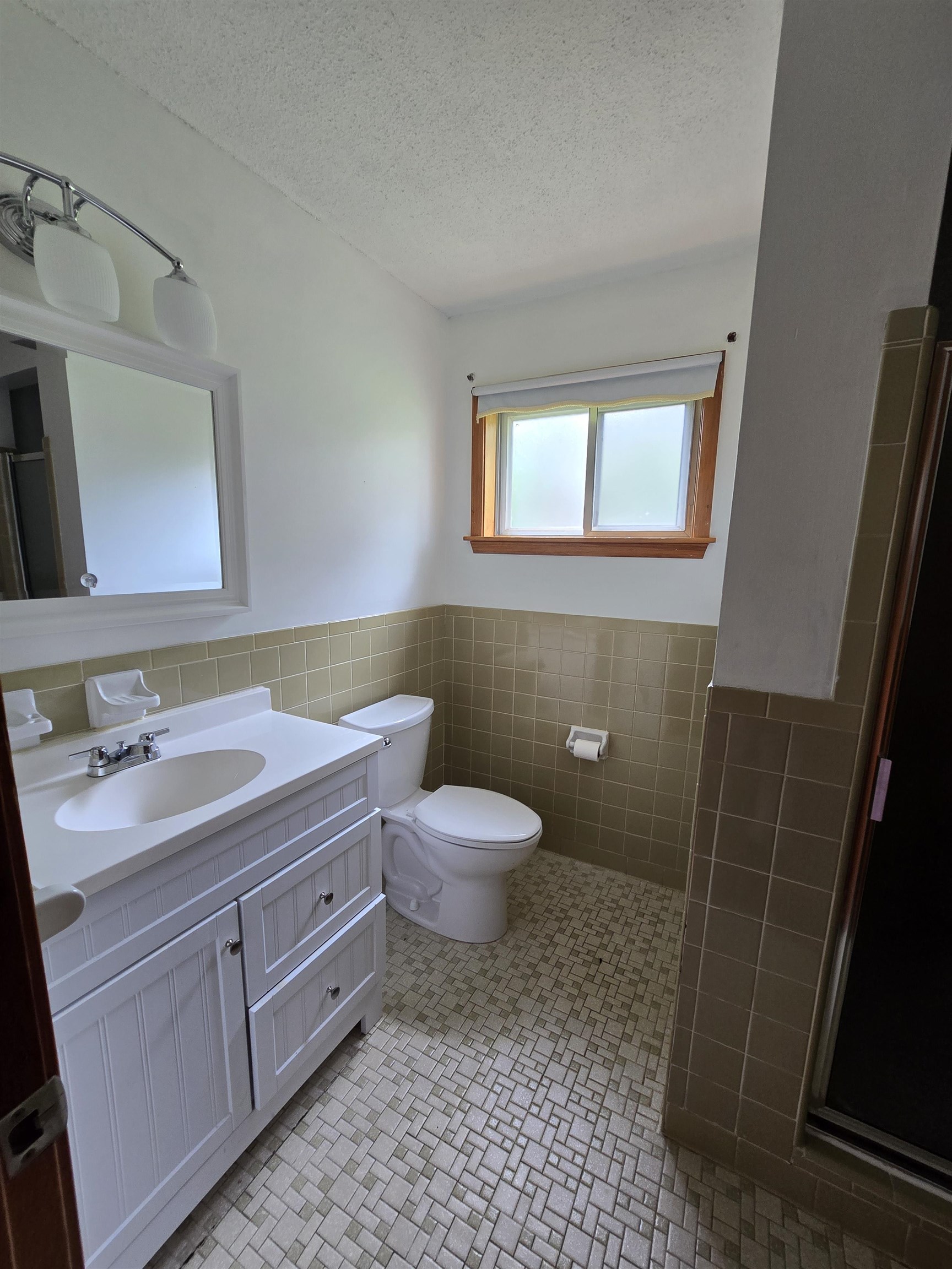 8355 Craven Road Bartlett, TN 38002 - Photo 25 of 28 Bathroom with tile walls, vanity, a wainscoted wall, a textured ceiling, and a shower with shower door
