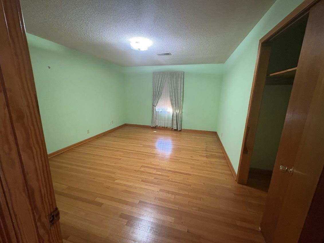 8355 Craven Road Bartlett, TN 38002 - Photo 26 of 28 Unfurnished bedroom with a textured ceiling and light wood-style flooring