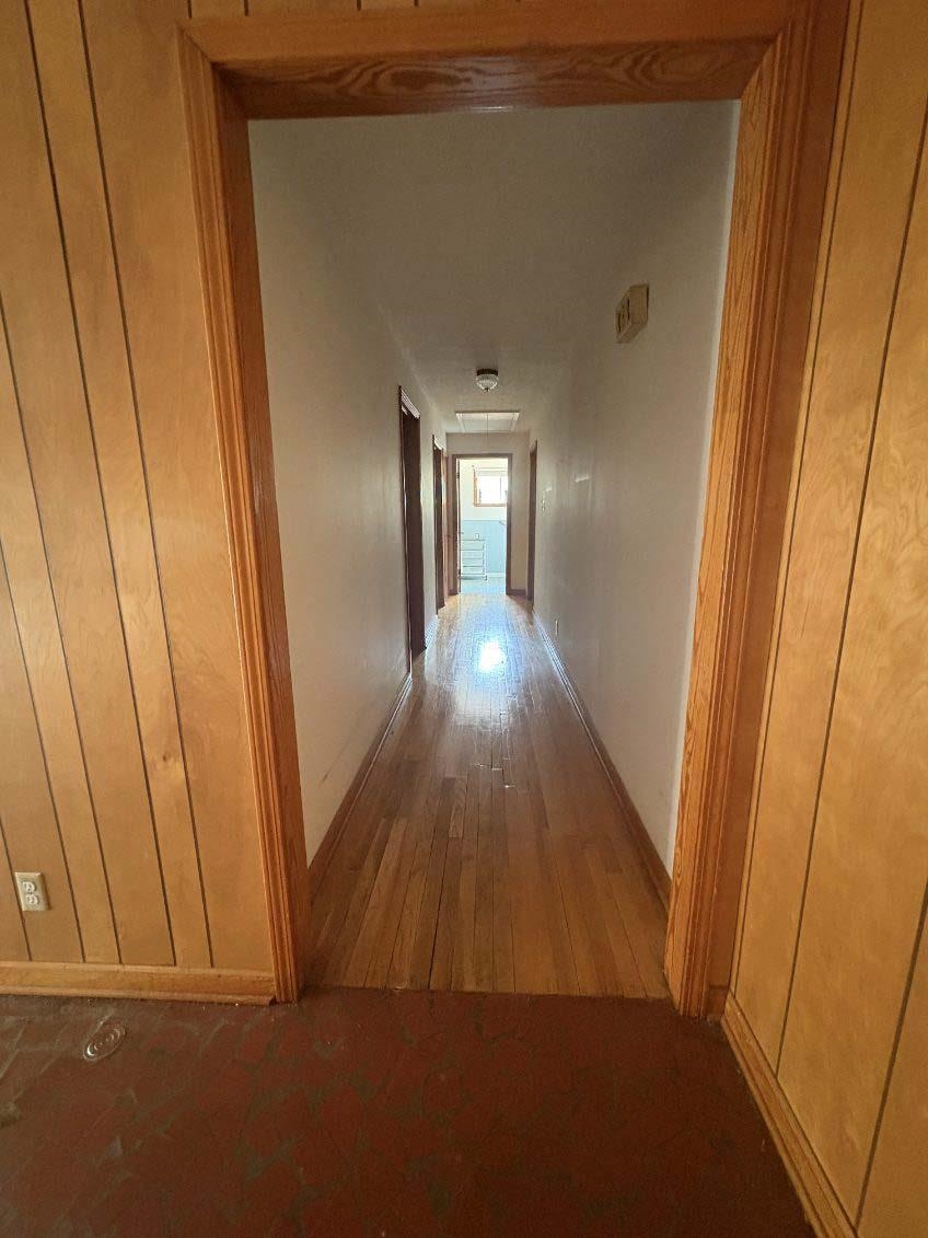 8355 Craven Road Bartlett, TN 38002 - Photo 28 of 28 Hall with hardwood / wood-style flooring and wooden walls