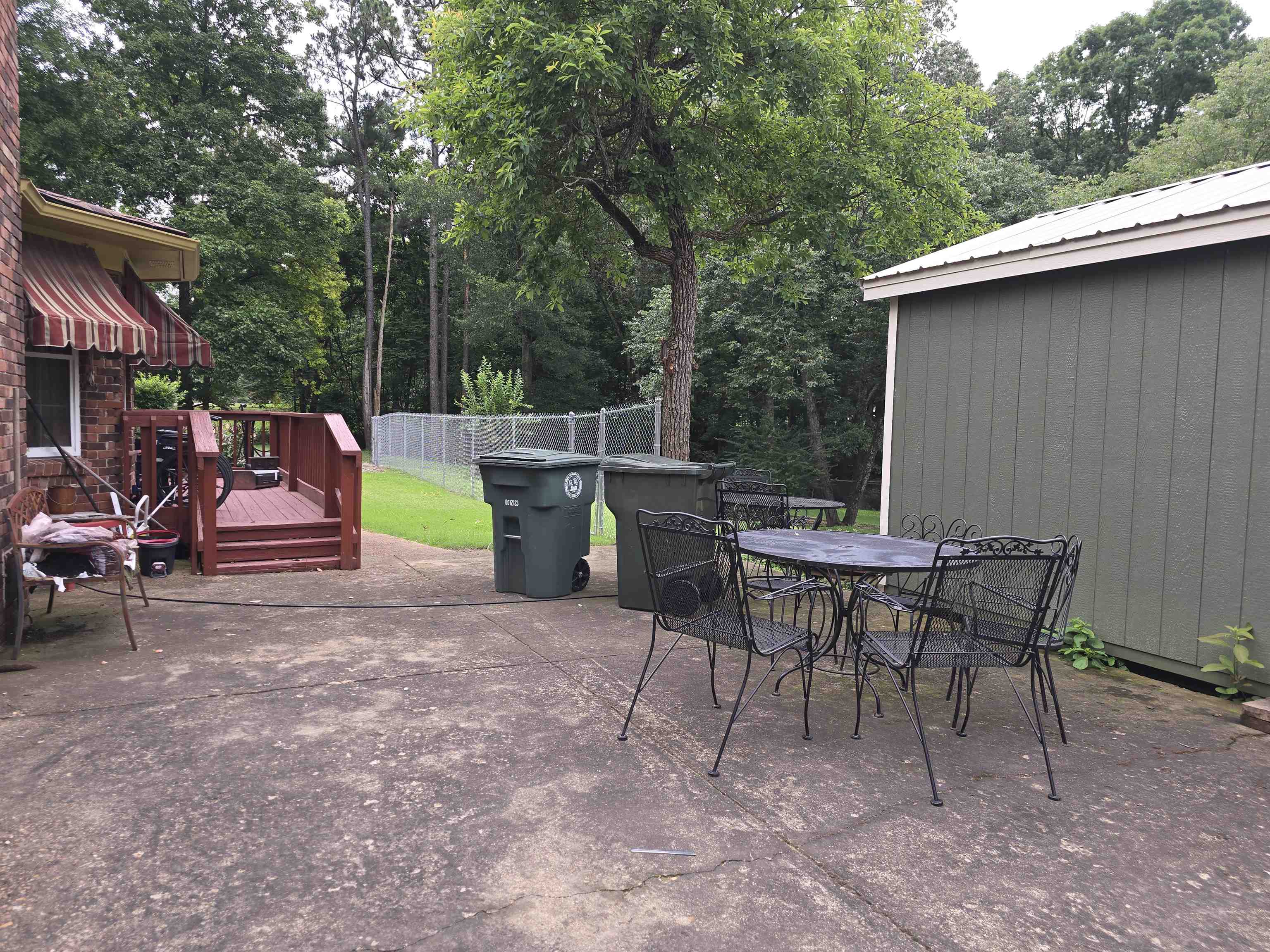 8355 Craven Road Bartlett, TN 38002 - Photo 5 of 28 View of patio featuring a wooden deck, outdoor dining area, and view of wooded area