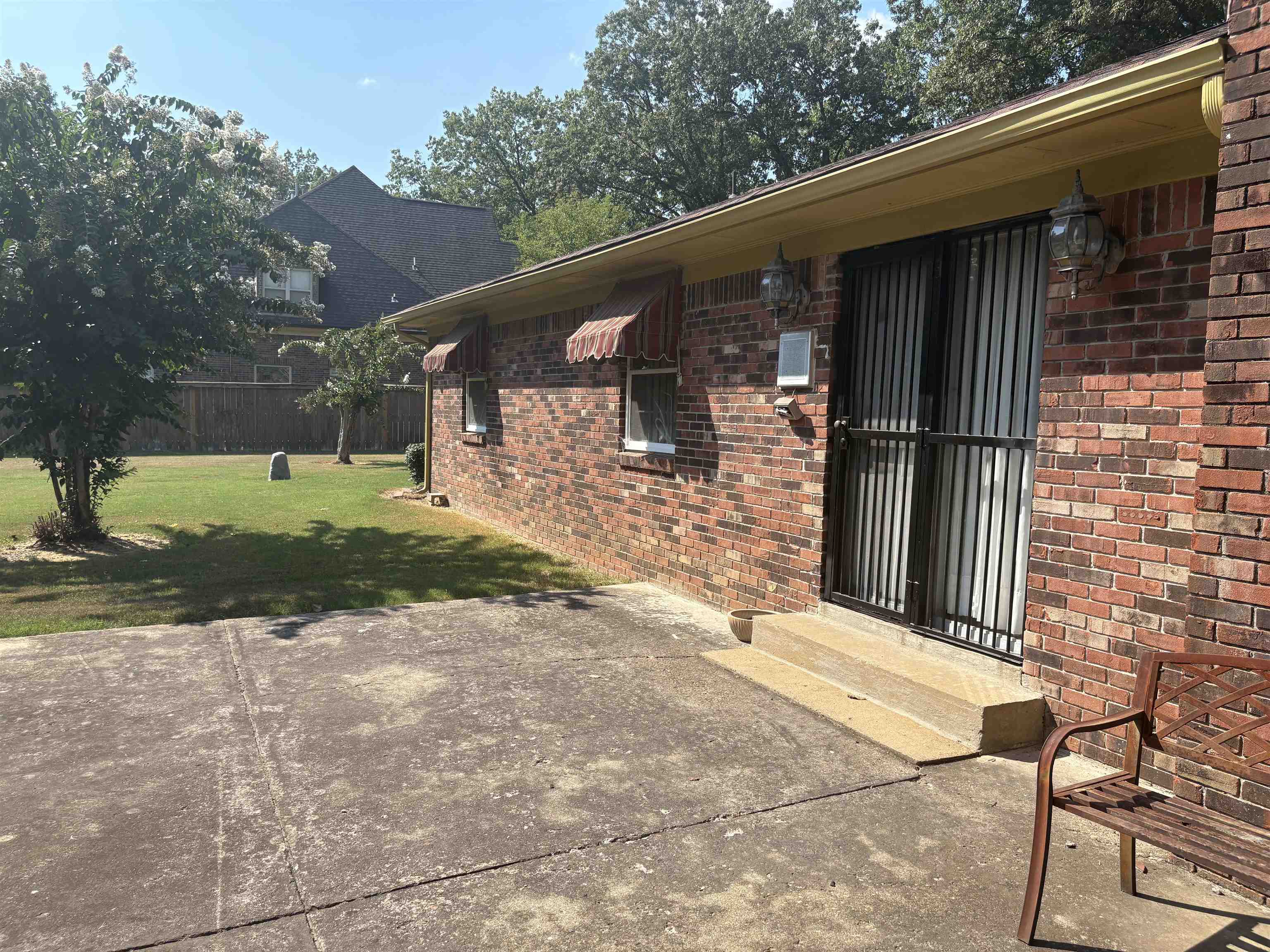 8355 Craven Road Bartlett, TN 38002 - Photo 7 of 28 Property entrance with brick siding and a lawn