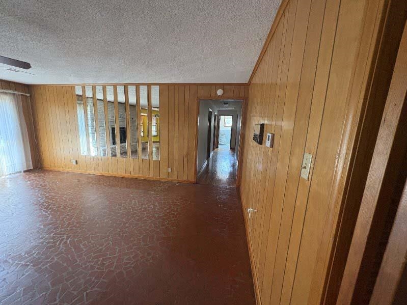 8355 Craven Road Bartlett, TN 38002 - Photo 10 of 28 Unfurnished den area featuring wood walls and a textured ceiling