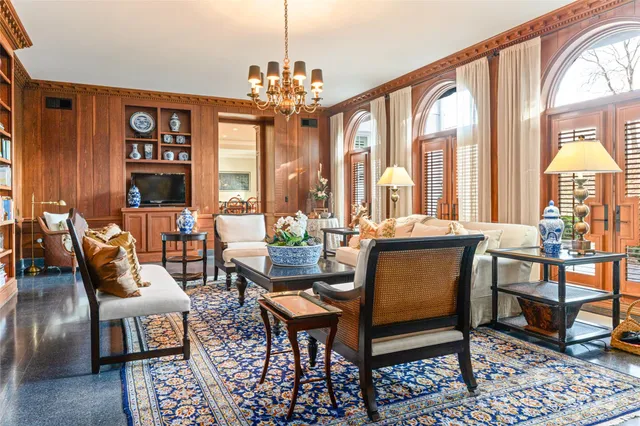 a living room with furniture and a chandelier