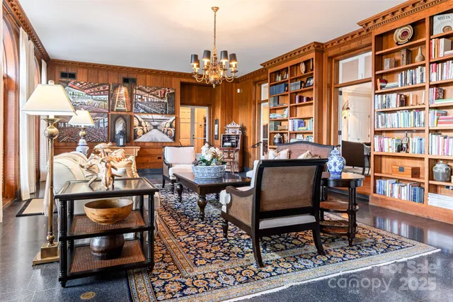 a outdoor living room with furniture and a book shelf