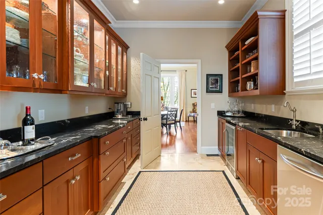 a large kitchen with stainless steel appliances granite countertop a stove a sink and a granite counter tops