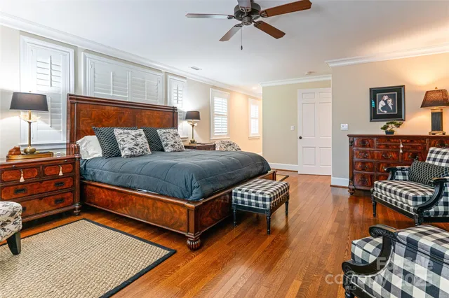 a bedroom with furniture and wooden floor