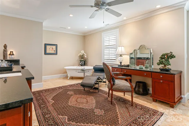 a living room with furniture a window and a potted plant