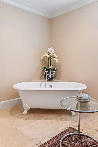 a white bath tub sitting next to a bathroom