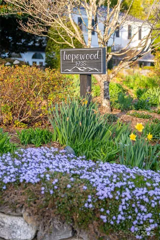 a street sign in front of flowers