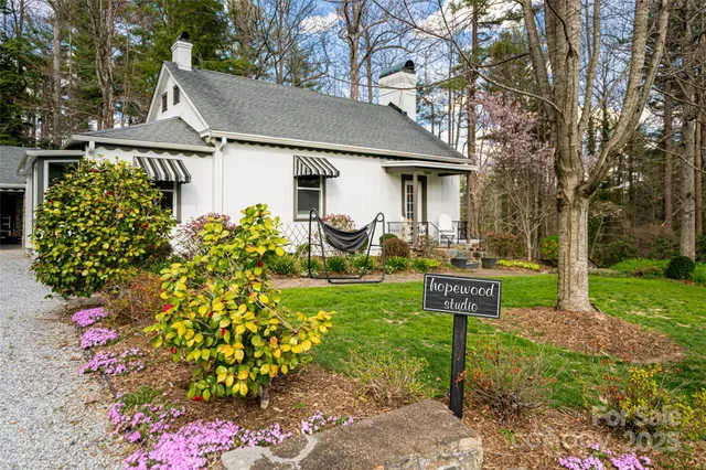 an aerial view of a house a yard and a fountain