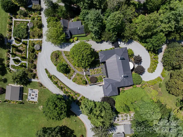an aerial view of residential houses with outdoor space and street view