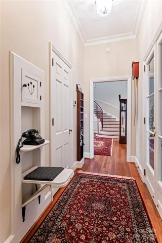 a living room with stainless steel appliances furniture and a rug