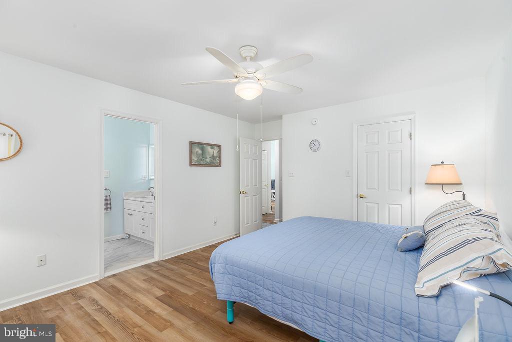 51 Martinique Circle Ocean Pines, MD 21811 - Photo 17 of 49 a bedroom with a bed and a chandelier