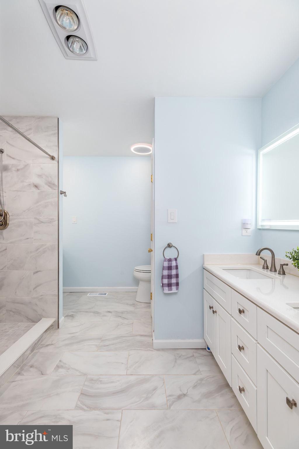 51 Martinique Circle Ocean Pines, MD 21811 - Photo 22 of 49 a bathroom with a granite countertop sink and a mirror