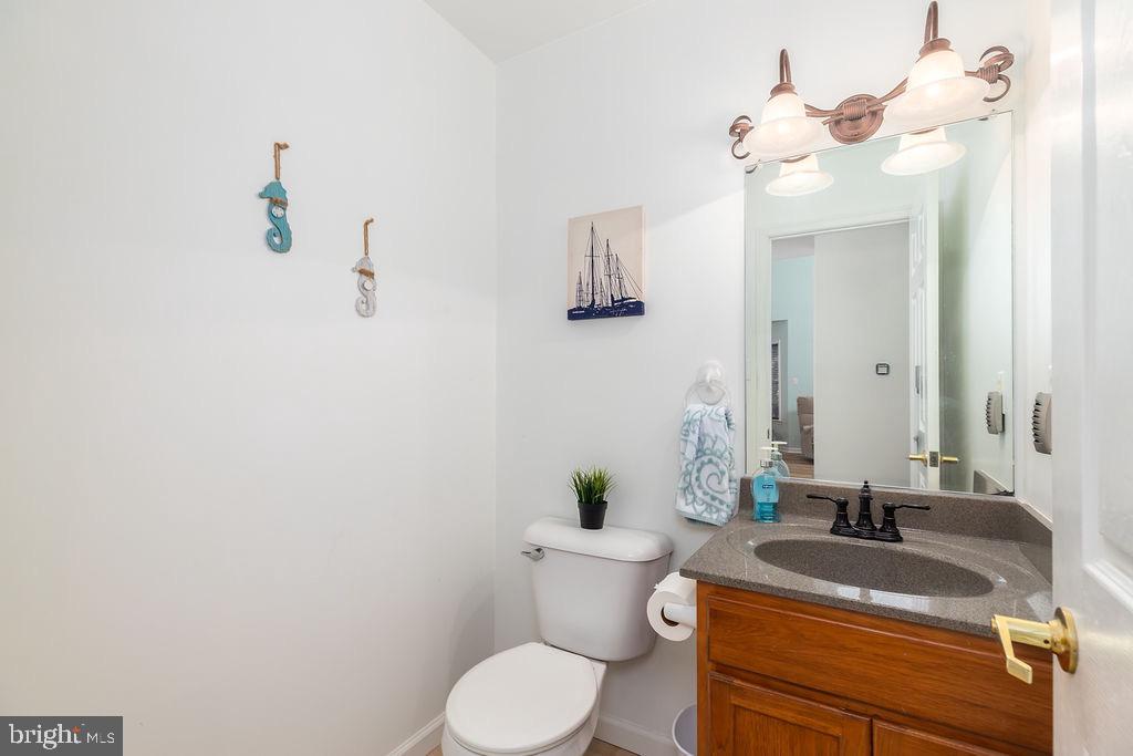 51 Martinique Circle Ocean Pines, MD 21811 - Photo 23 of 49 a bathroom with a granite countertop sink a toilet and mirror