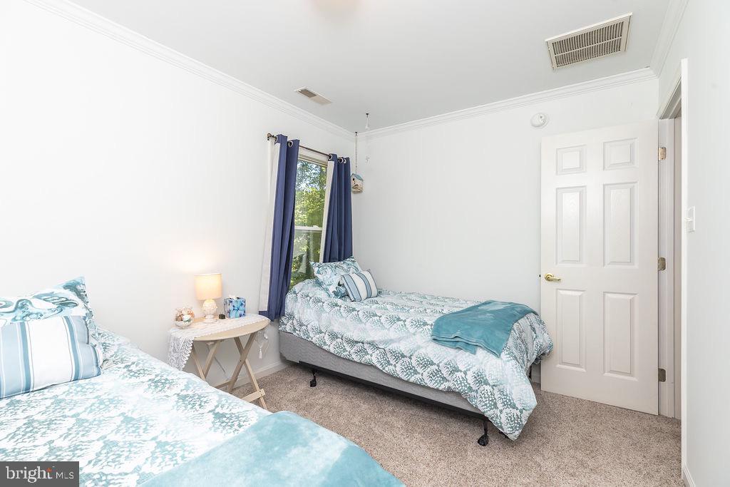 51 Martinique Circle Ocean Pines, MD 21811 - Photo 26 of 49 a bedroom with a bed and a table in it