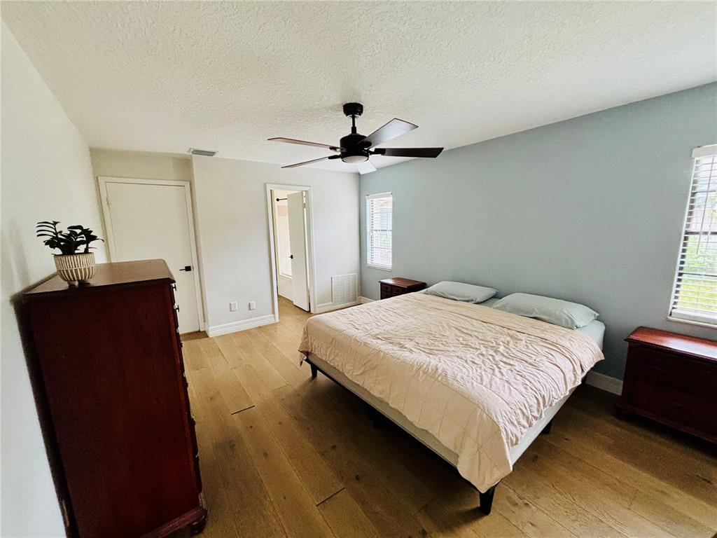 1045 Shaffer Trail Oviedo, FL 32765 - Photo 16 of 30 a bedroom with a bed and a dresser