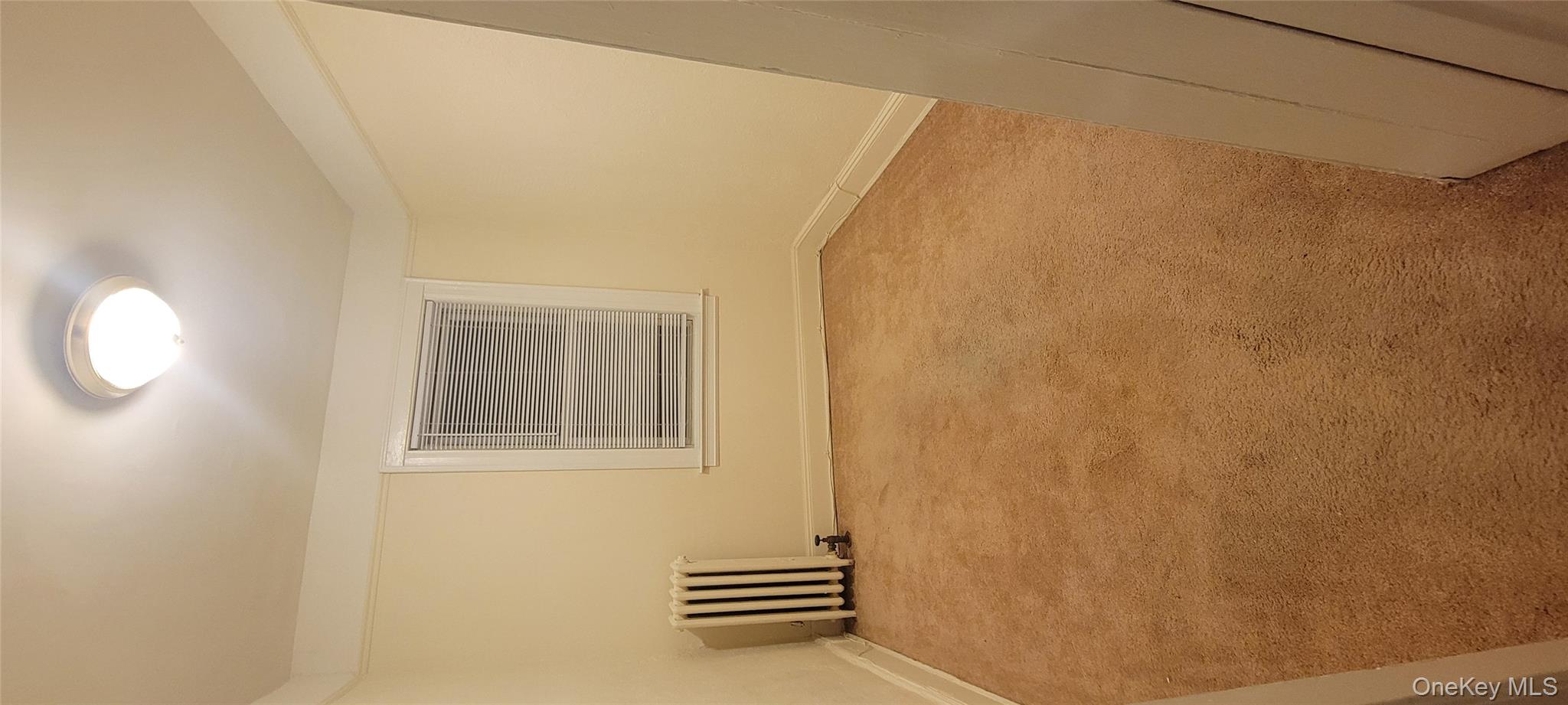 31-22 100th Street, Unit 2 Queens, NY 11369 - Photo 3 of 11 an empty room with windows