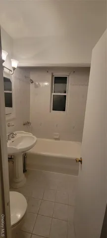 a bathroom with a sink a toilet and mirror