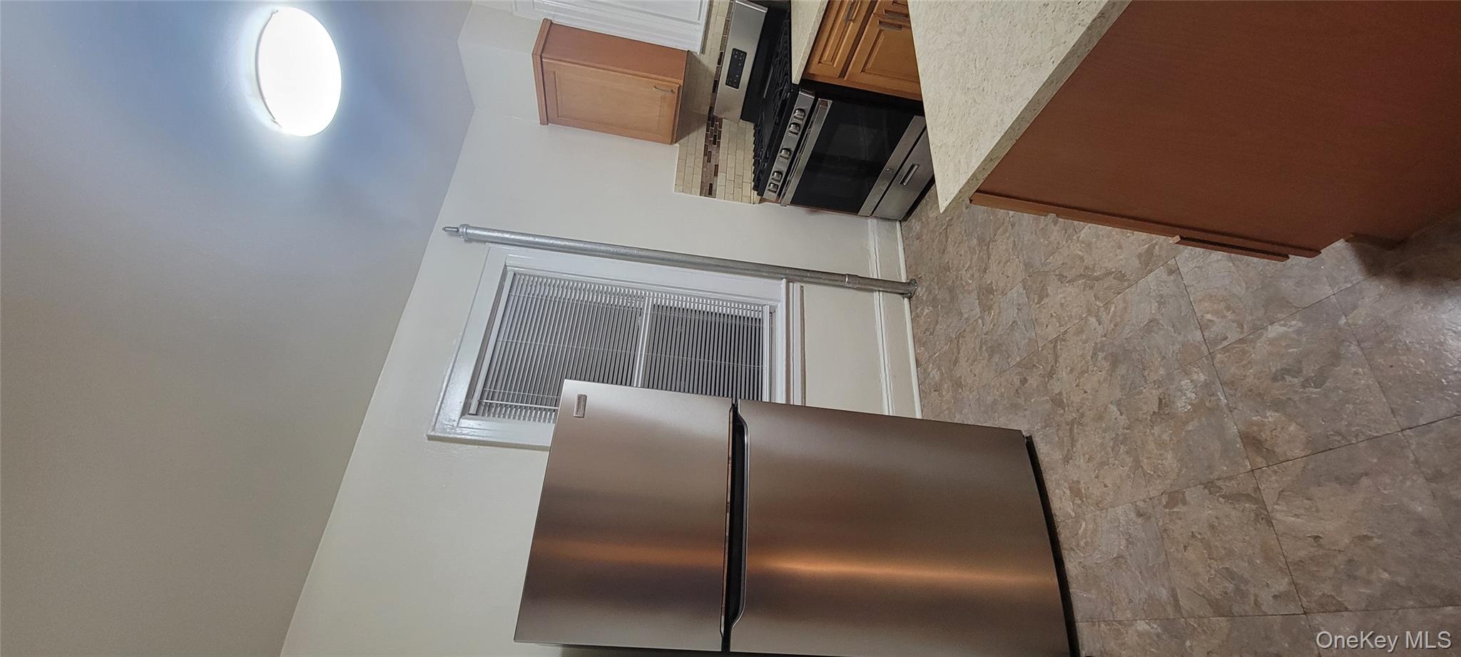 31-22 100th Street, Unit 2 Queens, NY 11369 - Photo 6 of 11 a view of a refrigerator in kitchen