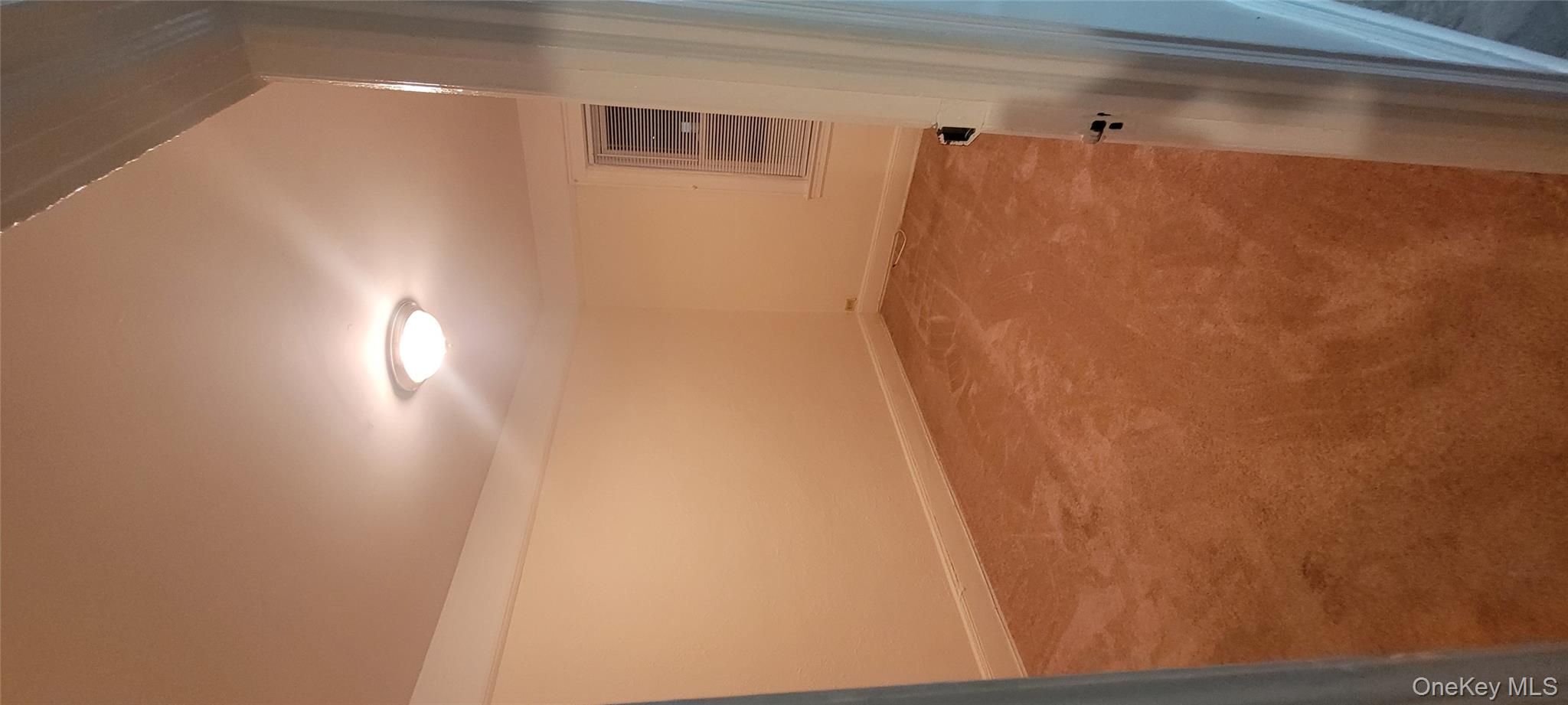 31-22 100th Street, Unit 2 Queens, NY 11369 - Photo 7 of 11 an empty room with an entryway