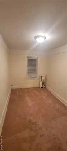 an empty room with a empty space and windows